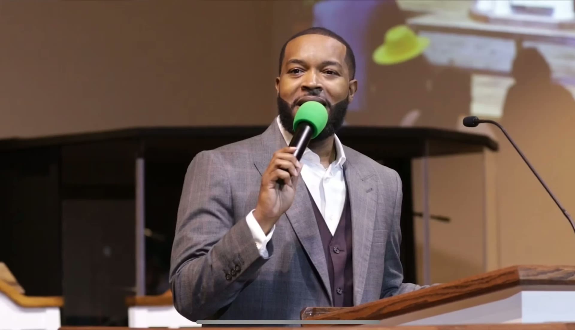Carlton Pulley preaching with a microphone