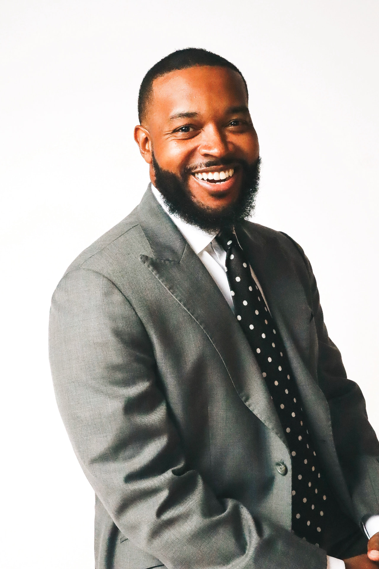 Carlton Pulley in a grey suit, studio portrait